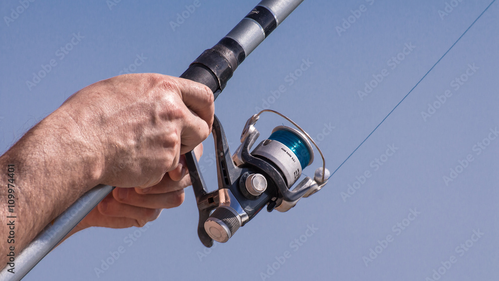 holding a fishing pole holding a fishing pole