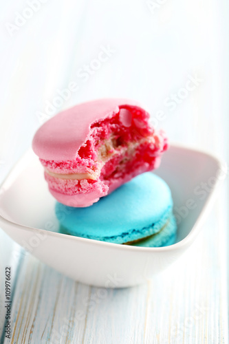 Tasty french macarons on a blue wooden table