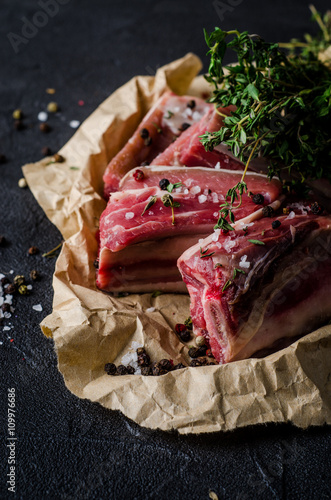 Wallpaper Mural Raw bef ribs with thyme and spices on dark slate background. Selective focus Torontodigital.ca