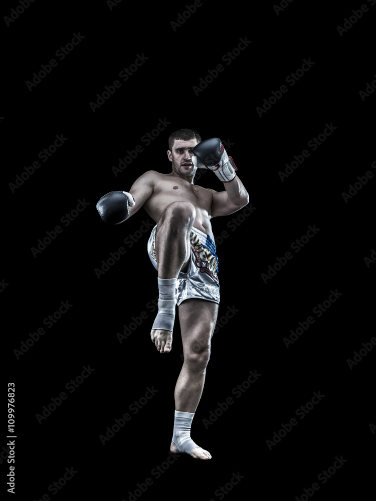Young thai boxing fighter isolated on black background Young thai boxing fighter isolated on black background