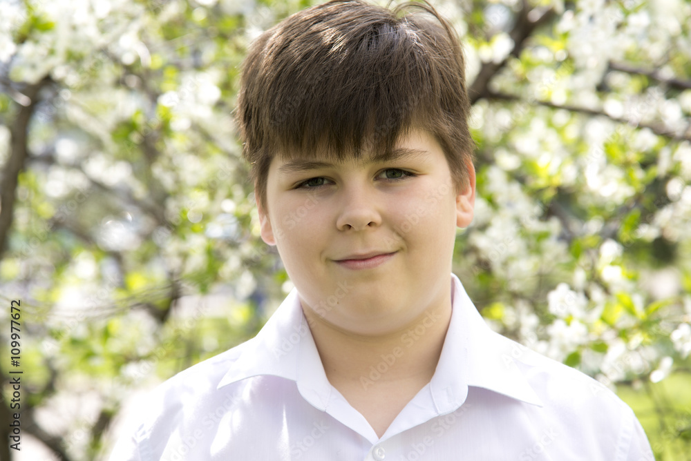 Portrait of a boy teenager in spring garden Portrait of a boy teenager in spring garden