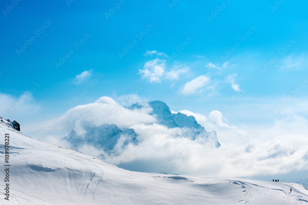 Plakat beautiful winter landscape of Dombaj with blue sky, clouds and d