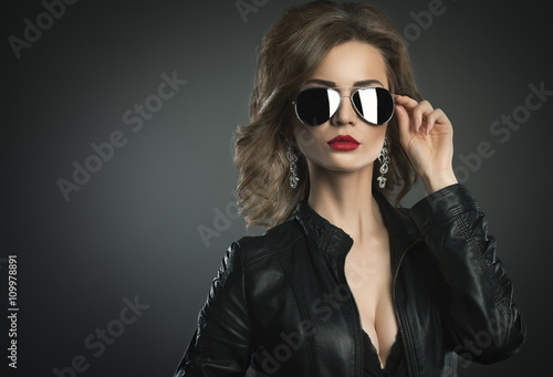 Fashion model young woman a pose in sunglasses.