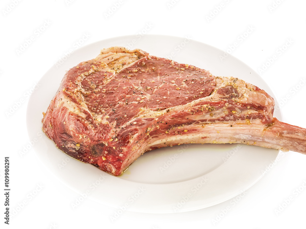 Bone-in Raw seasoned rib eye steak
