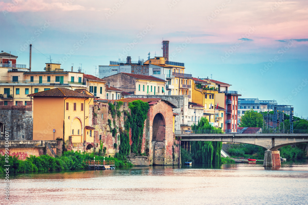 Old buildings along river Arno in Pisa, Italy.