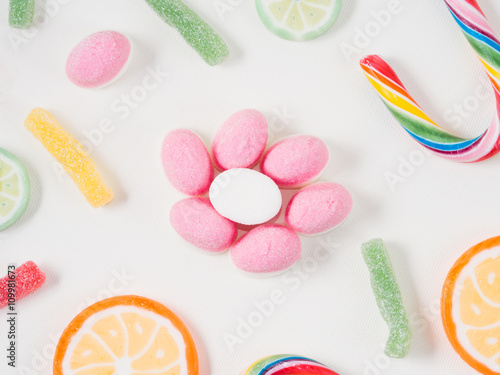 Fruit lollipops and candies on white canvas background