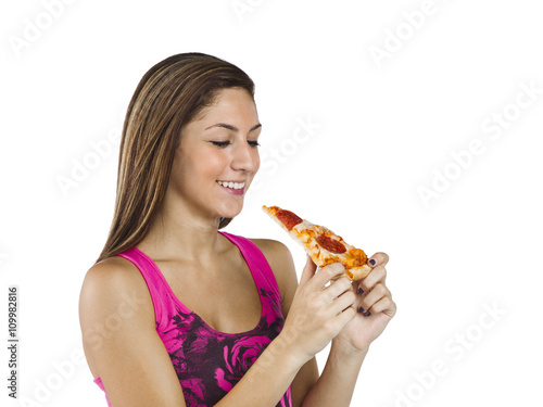 side view of a teenage girl holding a slice pizza.