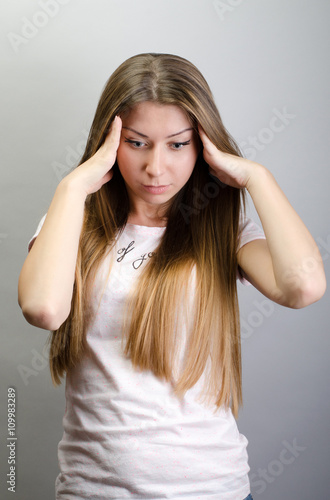 Portrait of a beautiful young woman thinking