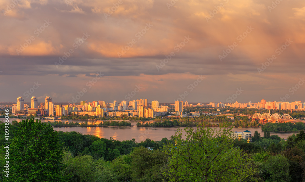 View of Kiev city from Botanic Garden before storm at sunset
