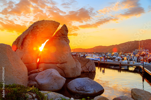 A sunset over lake with a port in the background