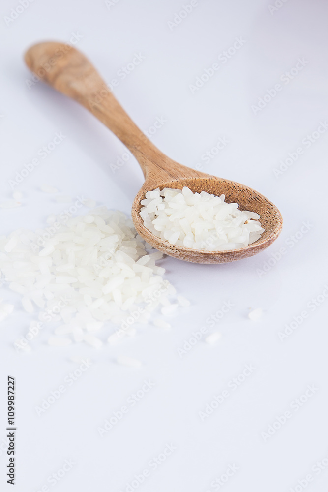 Raw and uncooked rice in wooden spoon,shallow Depth of Field,Focus on rice. Raw and uncooked rice in wooden spoon,shallow Depth of Field,Focus on rice.