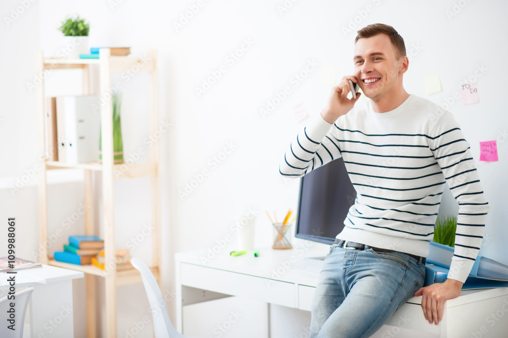 Handsome smiling guy talking on cell phone Handsome smiling guy talking on cell phone