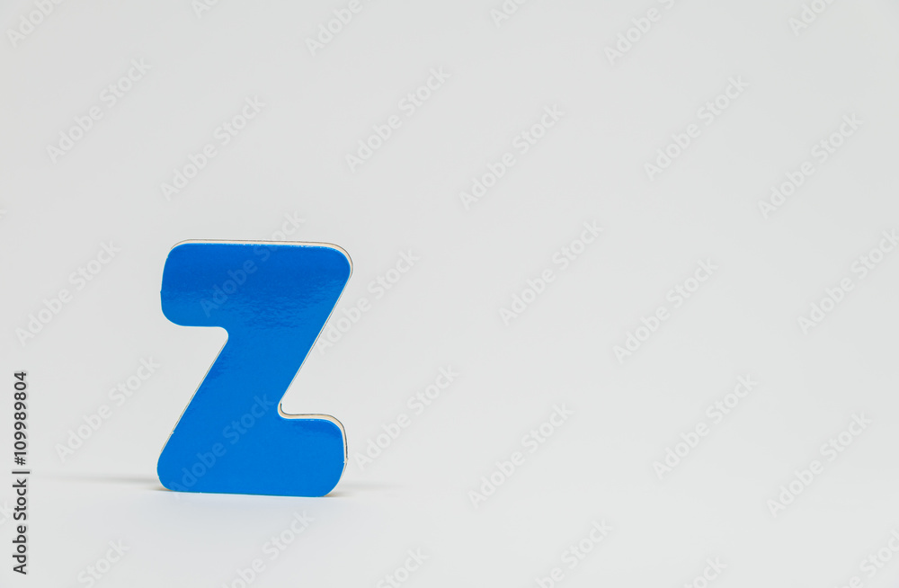 Blue wooden alphabet Z with white background and selective focus Blue wooden alphabet Z with white background and selective focus