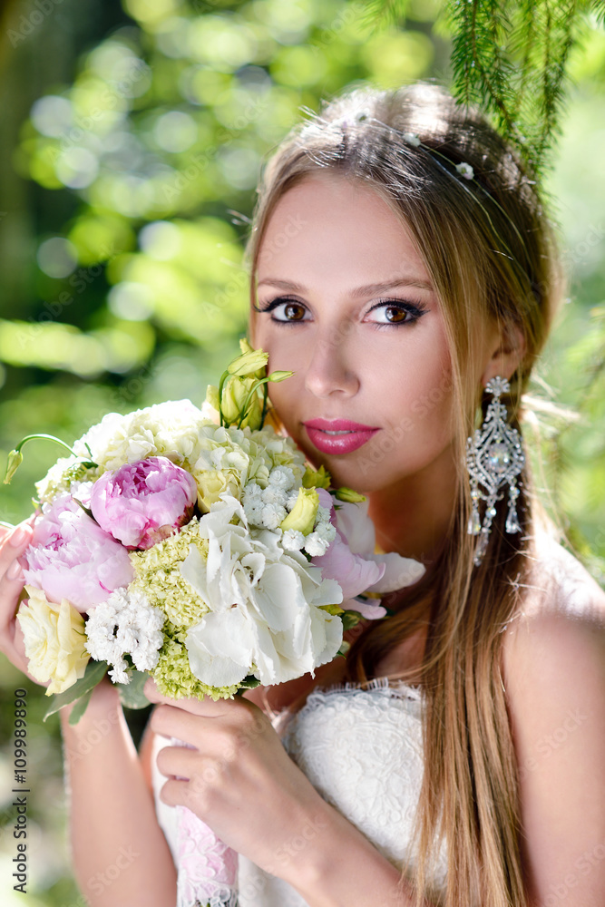 Beauty bride in bridal gown with bouquet and lace veil on the nature. Beautiful model girl in a white wedding dress. Female portrait in the park. Woman with hairstyle. Cute lady outdoors Beauty bride in bridal gown with bouquet and lace veil on the nature. Beautiful model girl in a white wedding dress. Female portrait in the park. Woman with hairstyle. Cute lady outdoors
