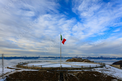 Italian flag on blue sky © elleonzebon