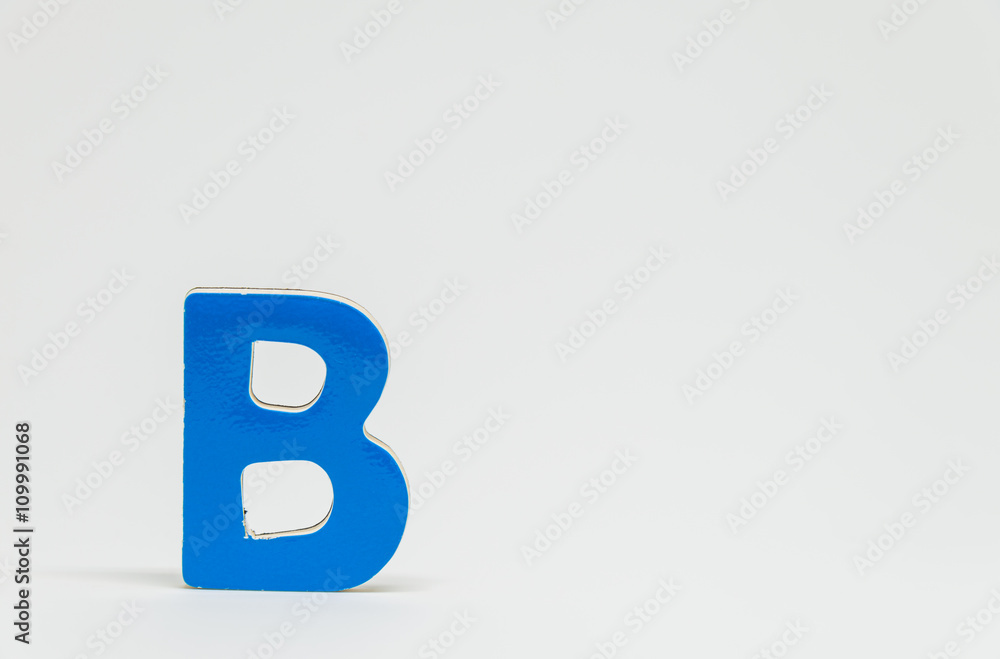 Blue wooden alphabet B with white background and selective focus Blue wooden alphabet B with white background and selective focus