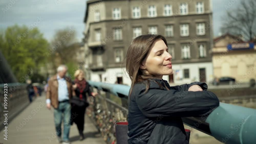 Young, happy woman walking on bridge in city
Young, happy woman walking on bridge in city