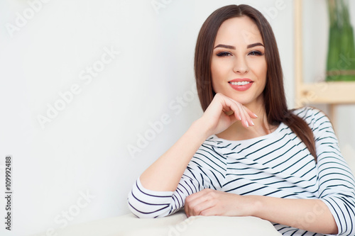 Positive woman sitting on the couch 