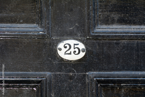House number 25 sign on door
