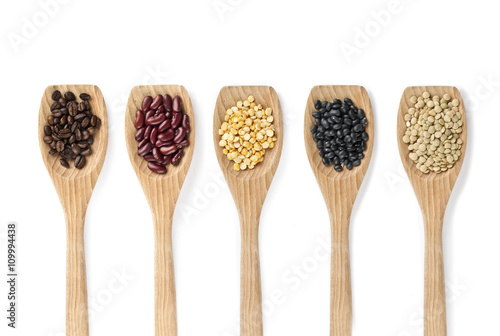assorted food grains on a wooden spoon