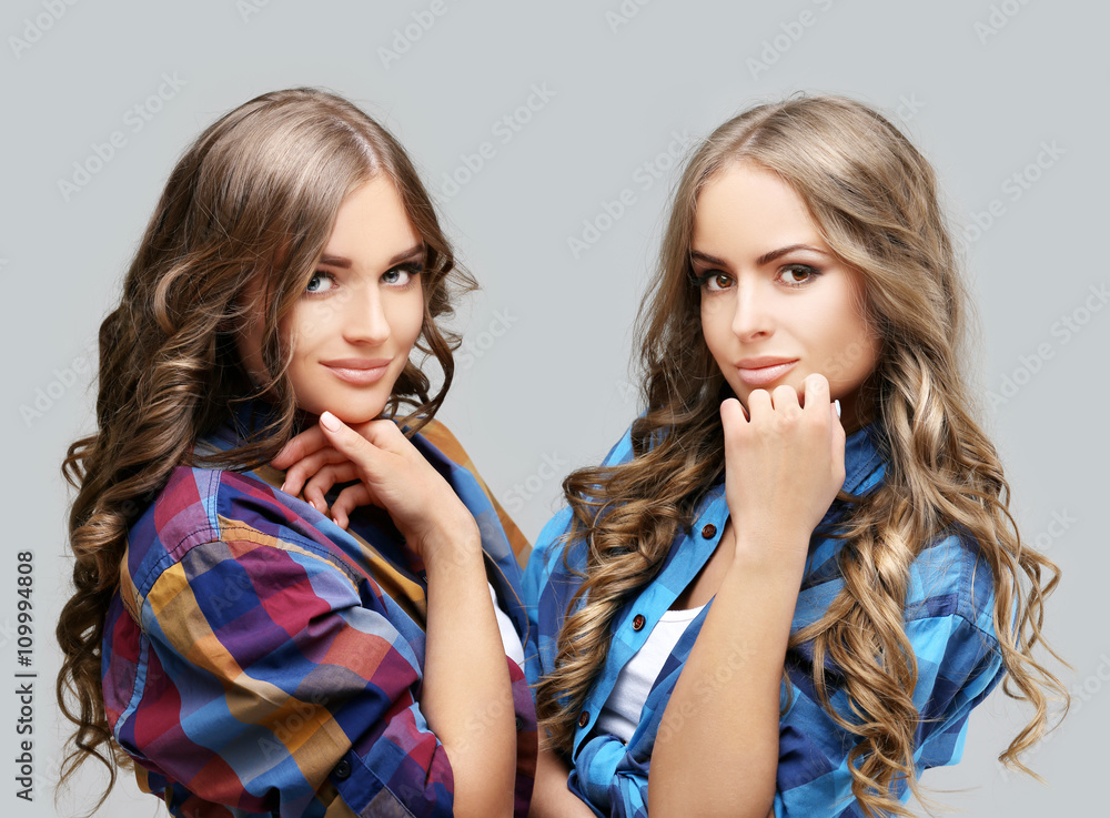 Lifestyle portrait of two beautiful best friends girl wearing stylish shirt having great time. Lifestyle portrait of two beautiful best friends girl wearing stylish shirt having great time.