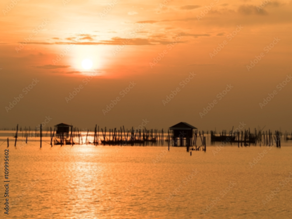 Blurred beautiful sunset above the sea in thailand. Silhouette of fish farms at sunset. Blurred beautiful sunset above the sea in thailand. Silhouette of fish farms at sunset.