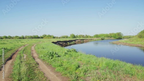 Beautiful spring landscape with river and road. European rural scene. photo