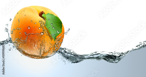 Fotografie Yellow apricot on a background of splashing cool water.