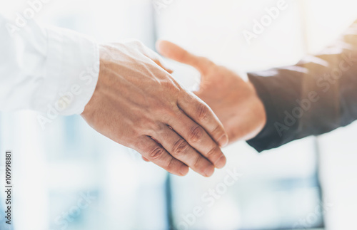 Business partnership meeting. Photo businessmans handshake. Successful businessmen handshaking after good deal. Horizontal, blurred background, film effect