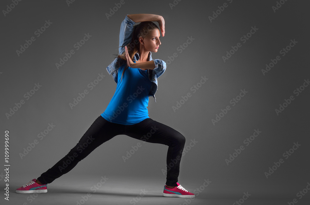 Fototapeta premium modern dancer poses in front of the studio background