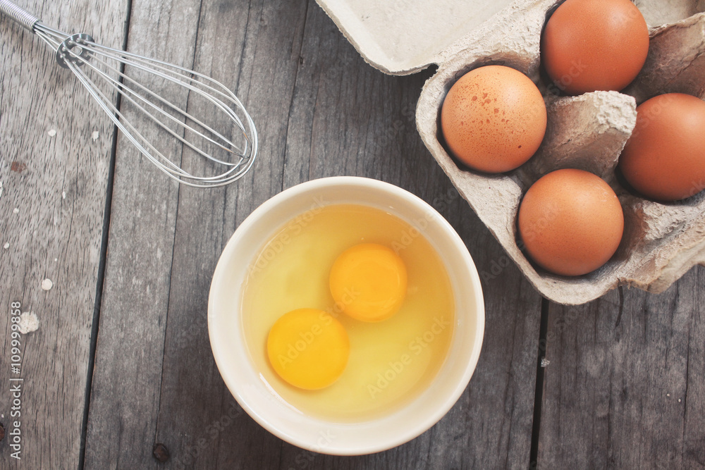 Eggs in box and bowl with whisk Eggs in box and bowl with whisk