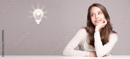 Photos Young woman next to creativity symbol.