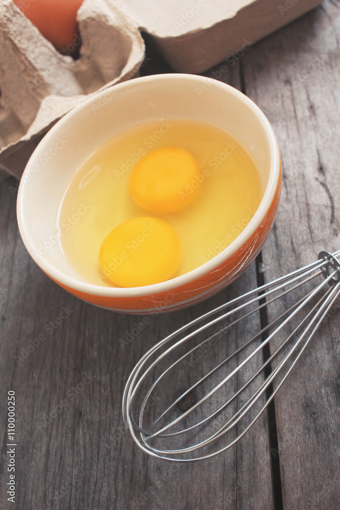 Eggs in box and bowl with whisk Eggs in box and bowl with whisk