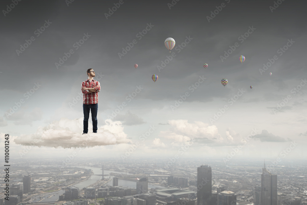 Man floating on cloud Man floating on cloud