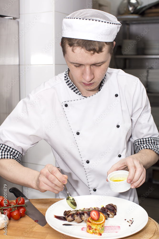 chef preparing food in the kitchen at the restaurant chef preparing food in the kitchen at the restaurant