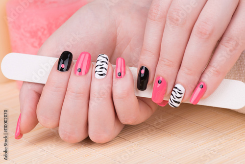 Manicure - Beautifully manicured woman fingernails. Feminine nail art with interesting animal print nail art.