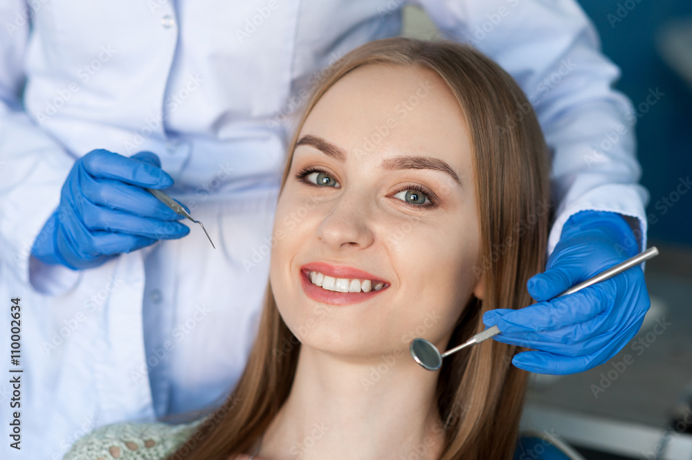 Dentist examining a patient's teeth Dentist examining a patient's teeth