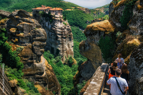Φωτογραφία People go on the background of The Holy Monastery of Varlaam