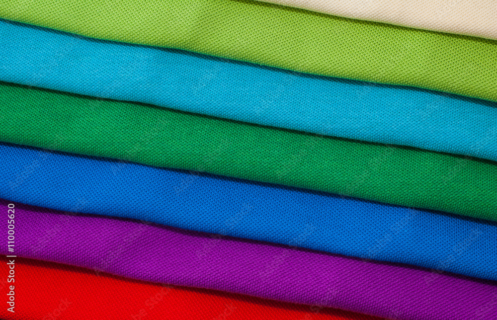 Pile of luxurious fine material 100% cotton polo shirts in various colors. Pile of luxurious fine material 100% cotton polo shirts in various colors.
