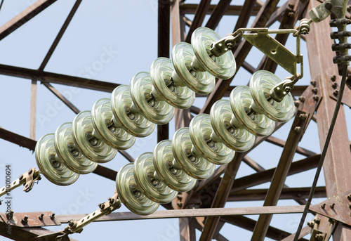 High-voltage insulator at high voltage power line pylon photo