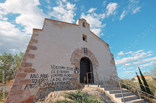 Little chapel with loutish graffiti photo