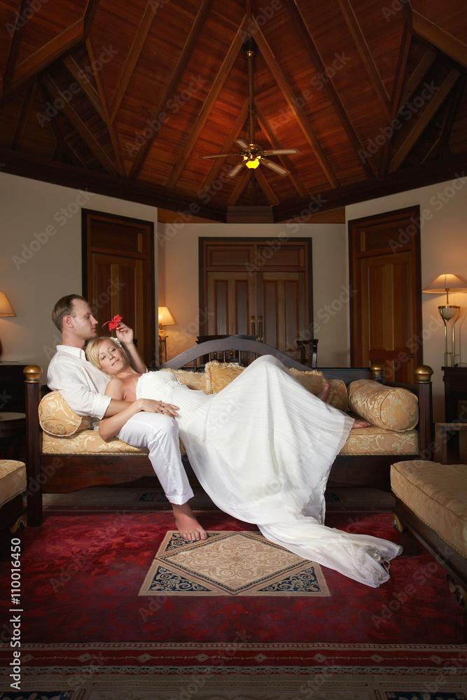 Nice couple lying on sofa in beautiful villa. Nice couple lying on sofa in beautiful villa.