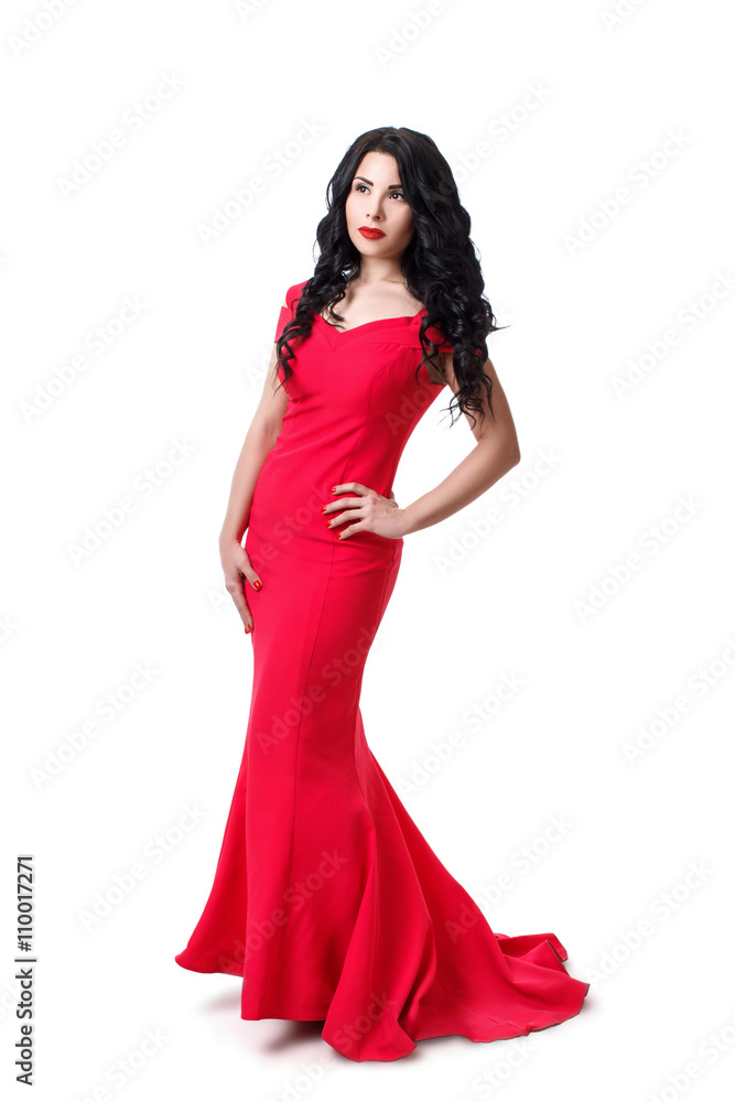 Elegant brunette girl in a black curly hair in a red evening dress. Isolated on white background