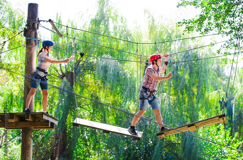 adventure climbing high wire park - people on course in mountain