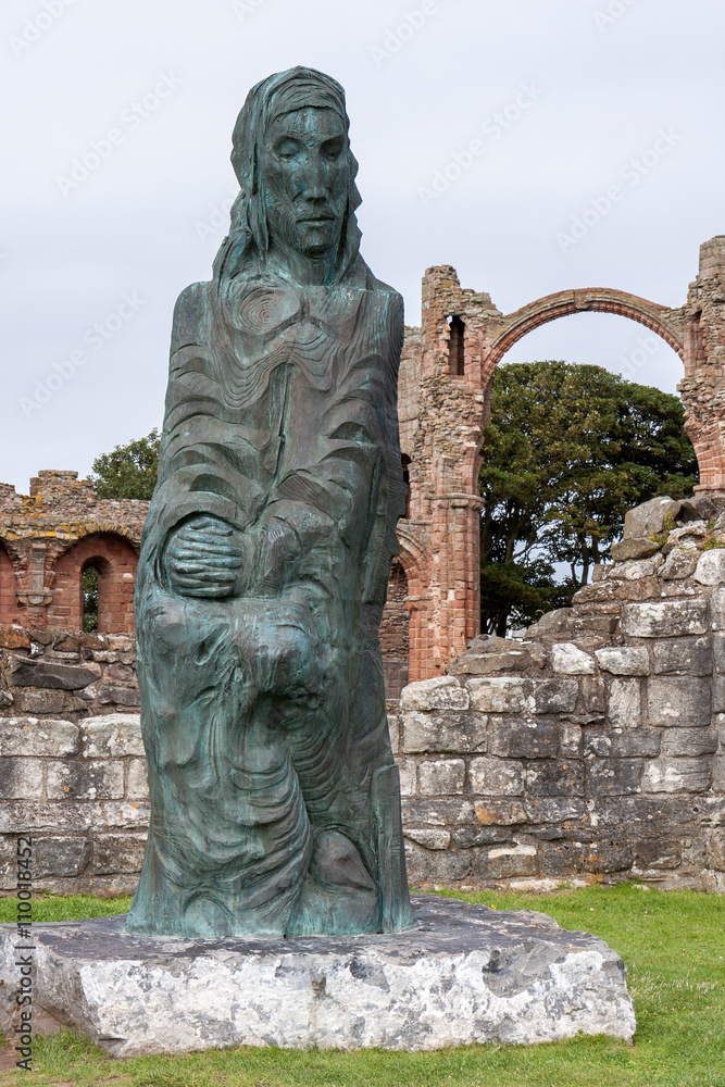 Fototapeta premium Statue amid the ruins of Lindisfarne Priory