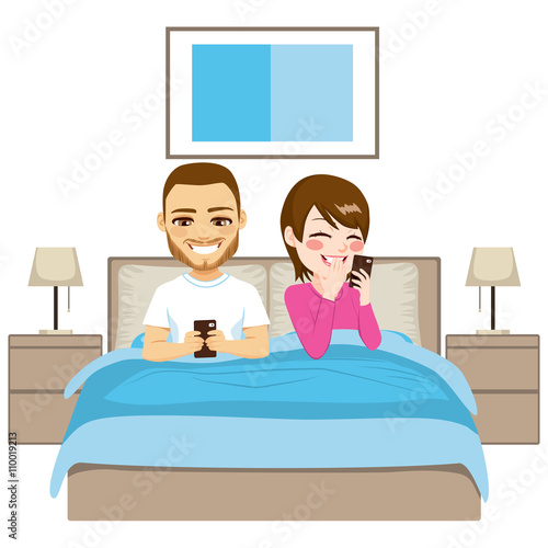 Young couple on bed using s...