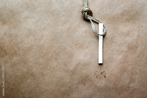 concept hangman's knot on kraft paper background with cigarette photo