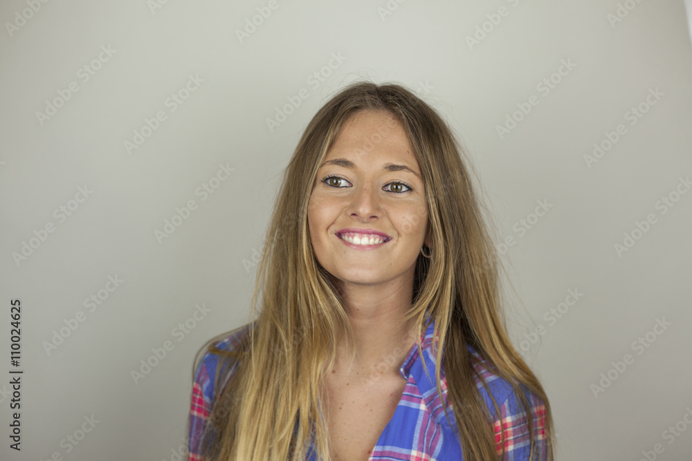 Fototapeta premium Close up portrait of beautiful smiley blonde woman with plaid sh