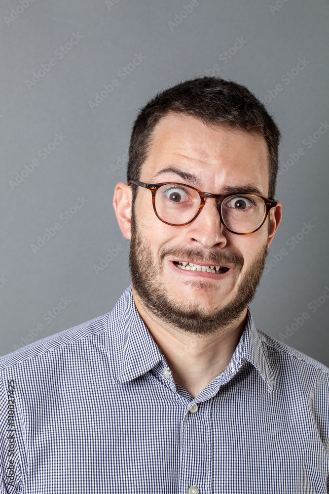 stressed out young bearded entrepreneur with eyeglasses grinding teeth stressed out young bearded entrepreneur with eyeglasses grinding teeth