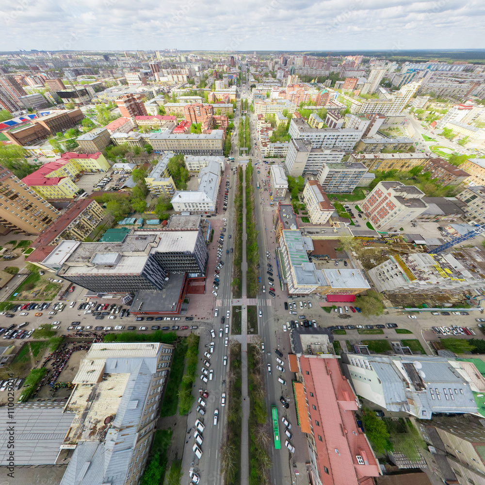 Fototapeta premium Aerial city view with crossroads and roads, houses, buildings, parks and parking lots, bridges. Copter shot. Panoramic image.